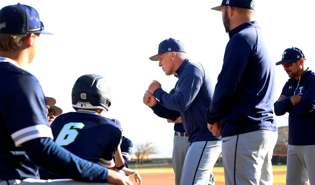 Timpanogos coach talking with players near the dugout