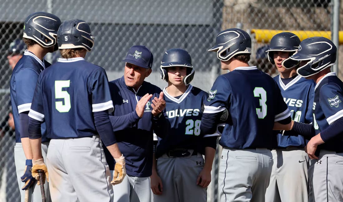 Timpanogos coach and players watching from the dugout